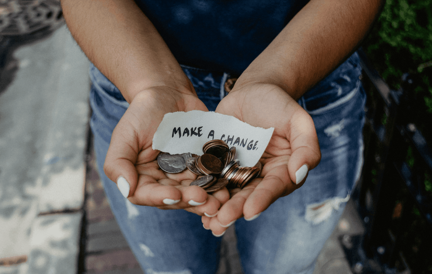 Woman holding coins in her hand asking for charity
