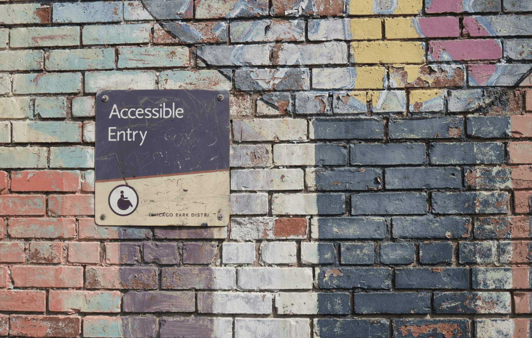 Accessible Entry sign on a colourful brick wall